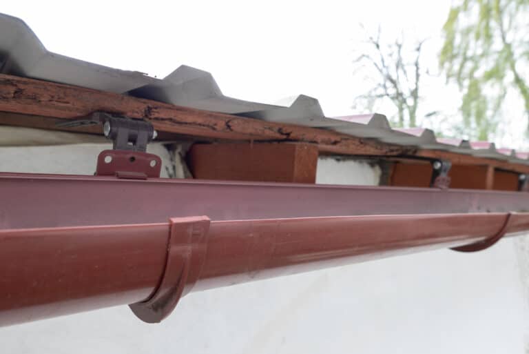 Gutter system for a metal roof. Holder gutter drainage system on the roof.