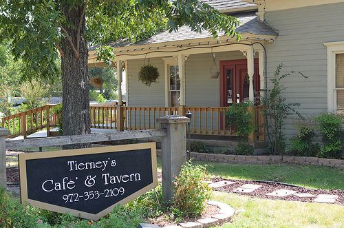Charming tavern entrance with porch and garden.