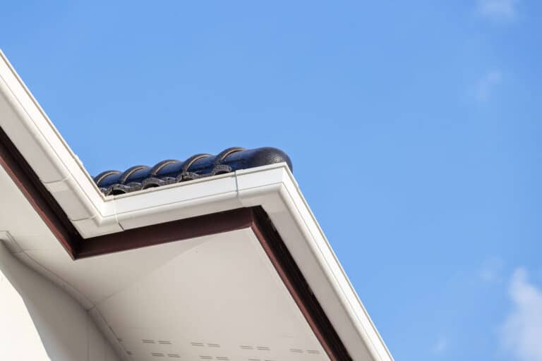 White gutter on the roof top of house